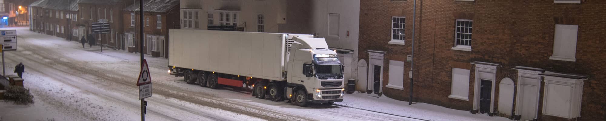 Large truck driving in snowy conditions in North Wales