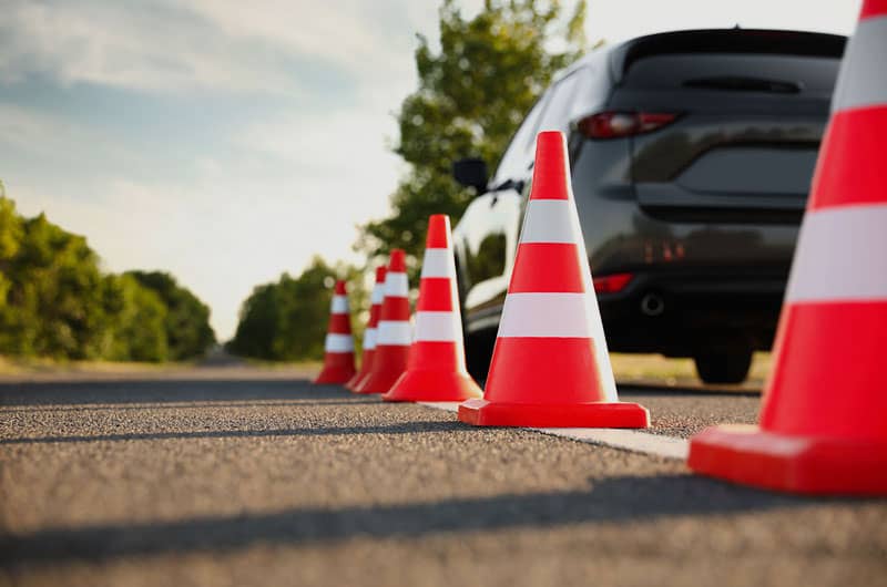 Learner driver navigating road cones