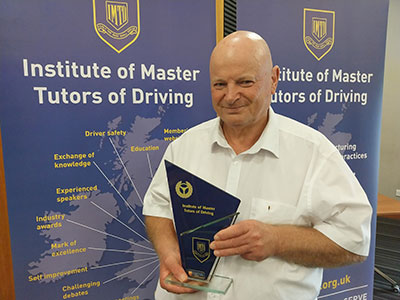 Stuart Walker holding Institute of Master Tutors of Driving Award